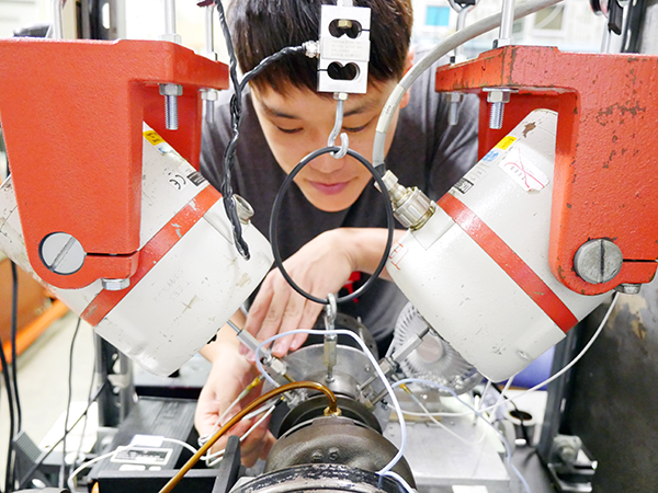 Photo of student working on test rig 