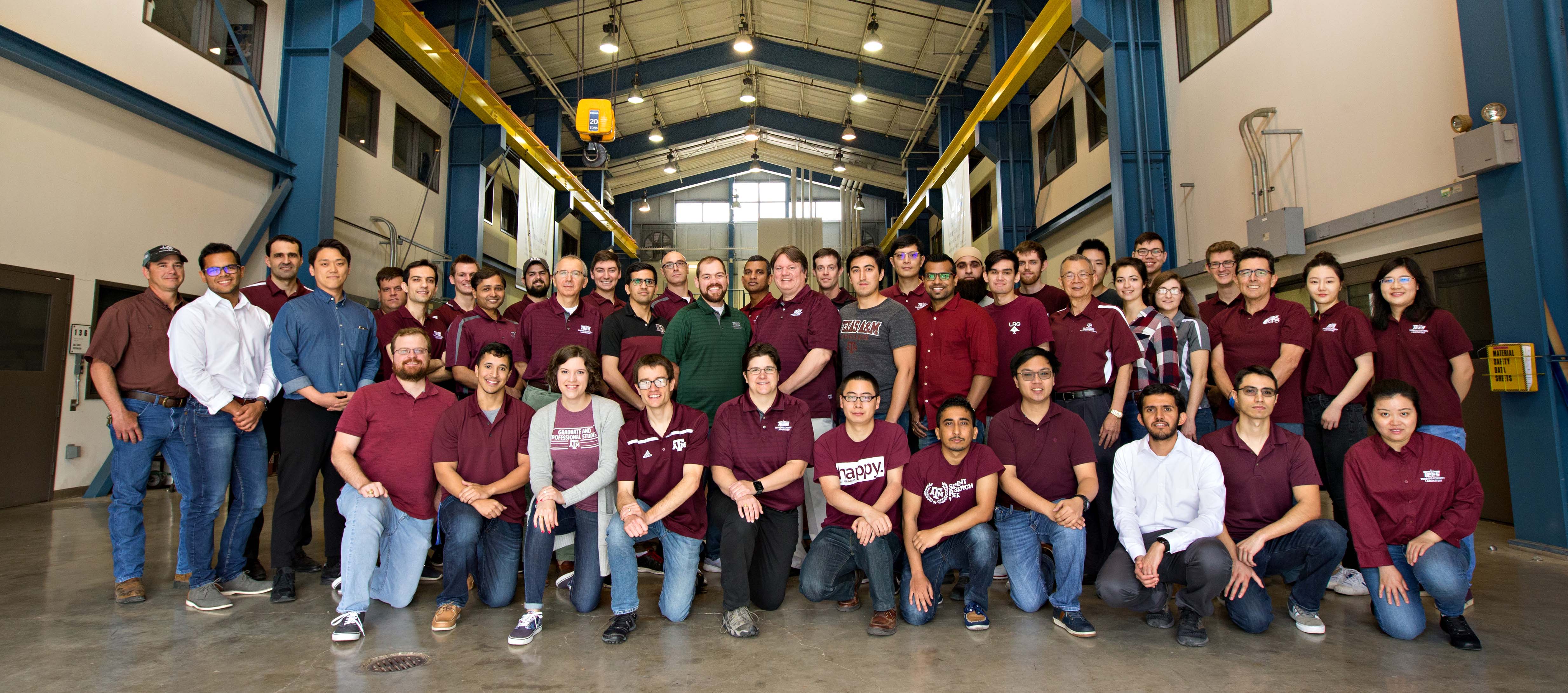 Photo of Turbo Lab faculty and students in High Bay of lab