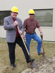 Dr. Eric Petersen and Carl Johnson with hard hats and shovels at the construction site of the new turbo lab office.